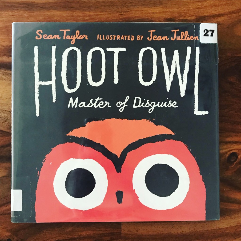 The image is a photograph of a book cover. The book says "Hoot Owl Master of Disguise" in white letters on a black background. Below the title is a large red and orange cartoon owl's face. 